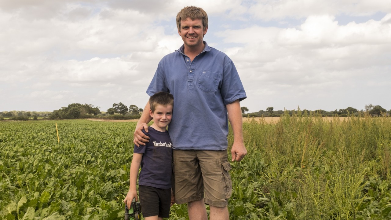 Robert and his son Ed standing next to the boundry between the treated and untreated section of the field with CONVISO® ONE
