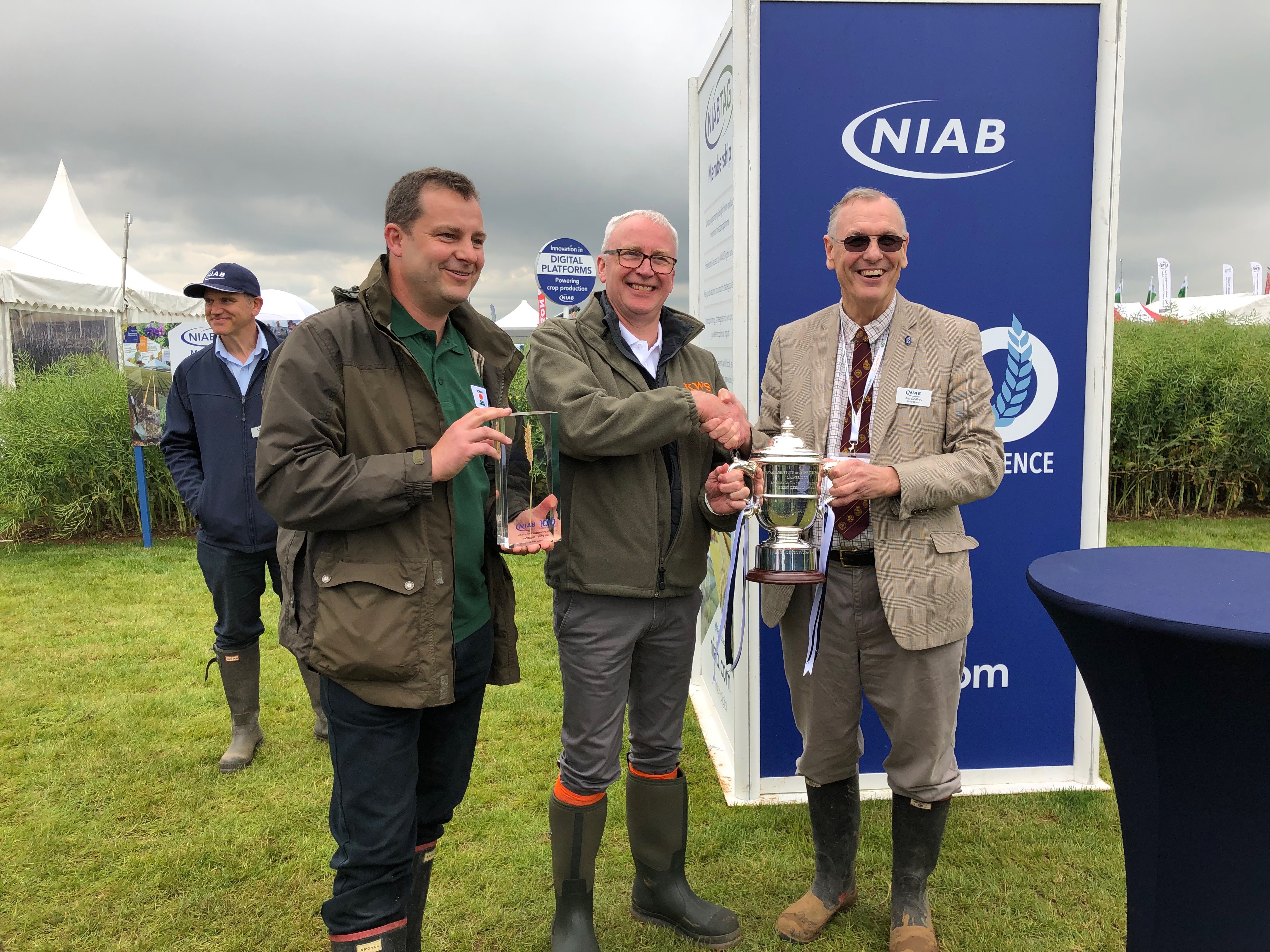 Mark-Dodds-and-Andrew-Newby-receive-the-NIAB-Cereals-Cup-from-NIAB-director-Jim-Godfrey.jpeg