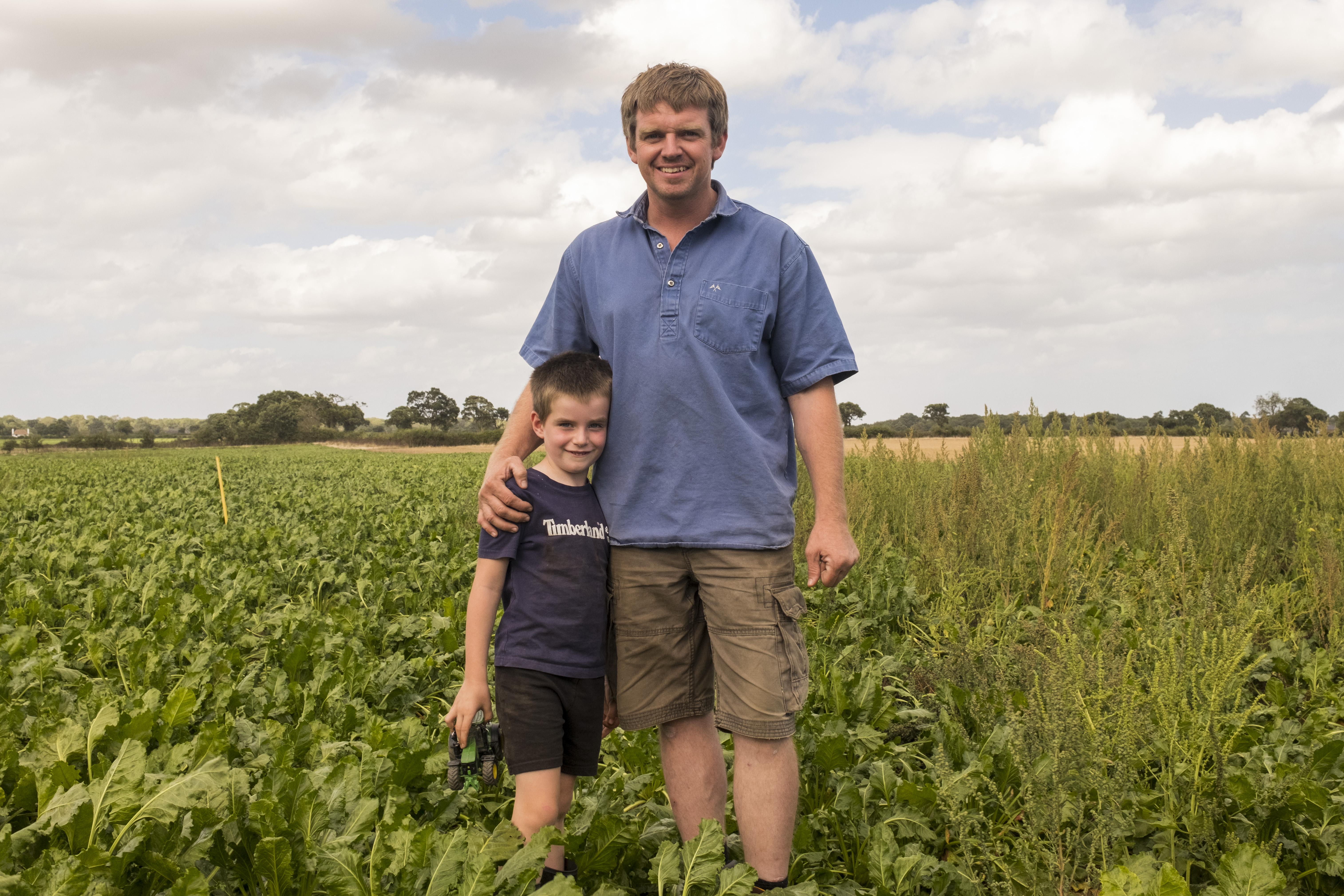 Robert and his son Ed standing next to the boundry between the treated and untreated section of the field with CONVISO® ONE