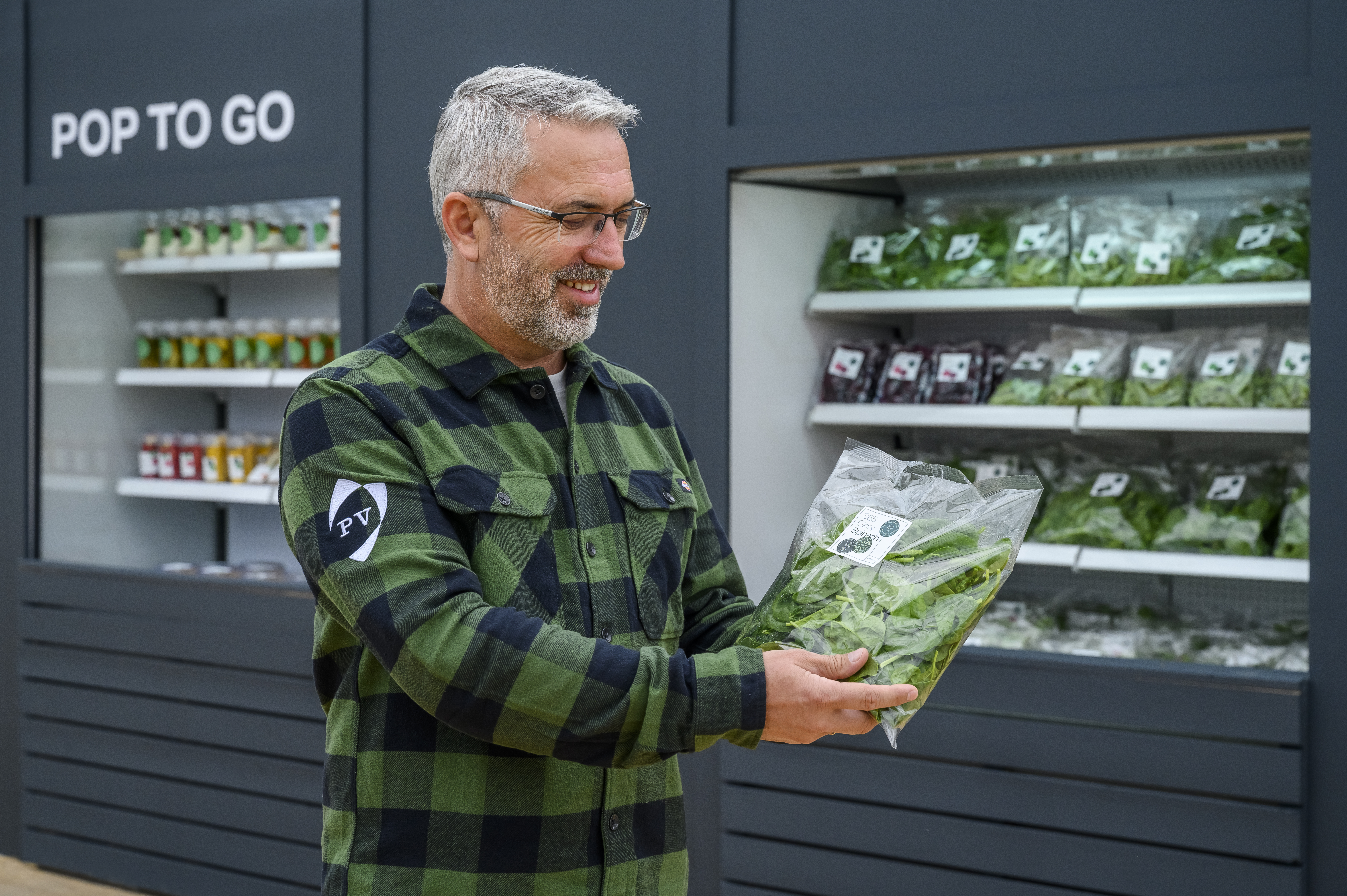 kws_pv_employee_looking_at_spinach_in_front_of_shelve_1.jpg