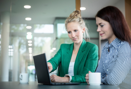 Team of employees coworking in front of a notebook