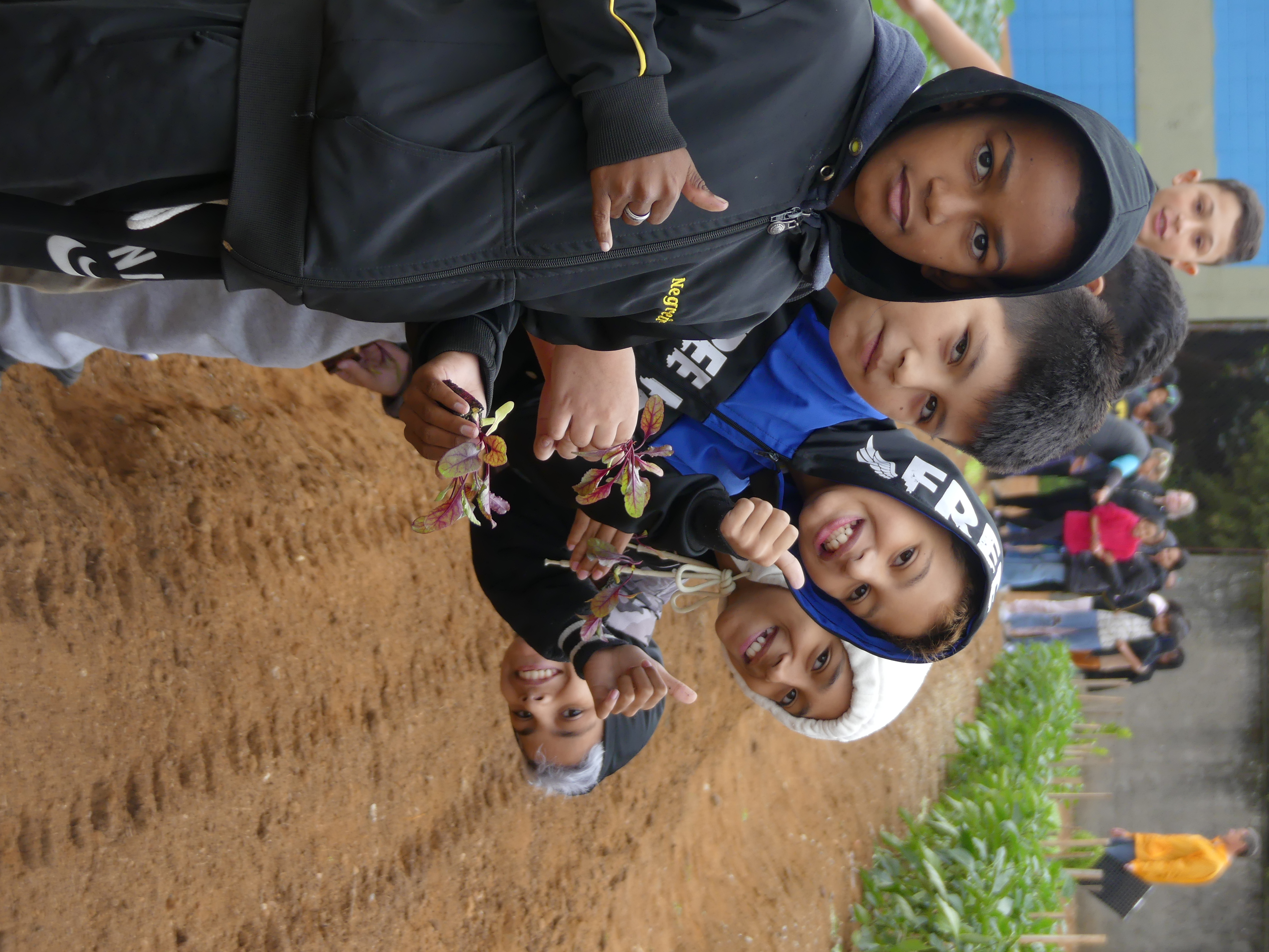Students posing for a picture while working on a field