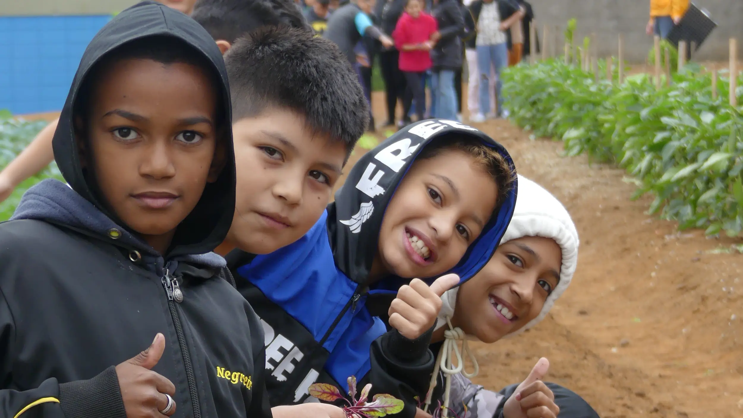 Students posing for a picture while working on a field