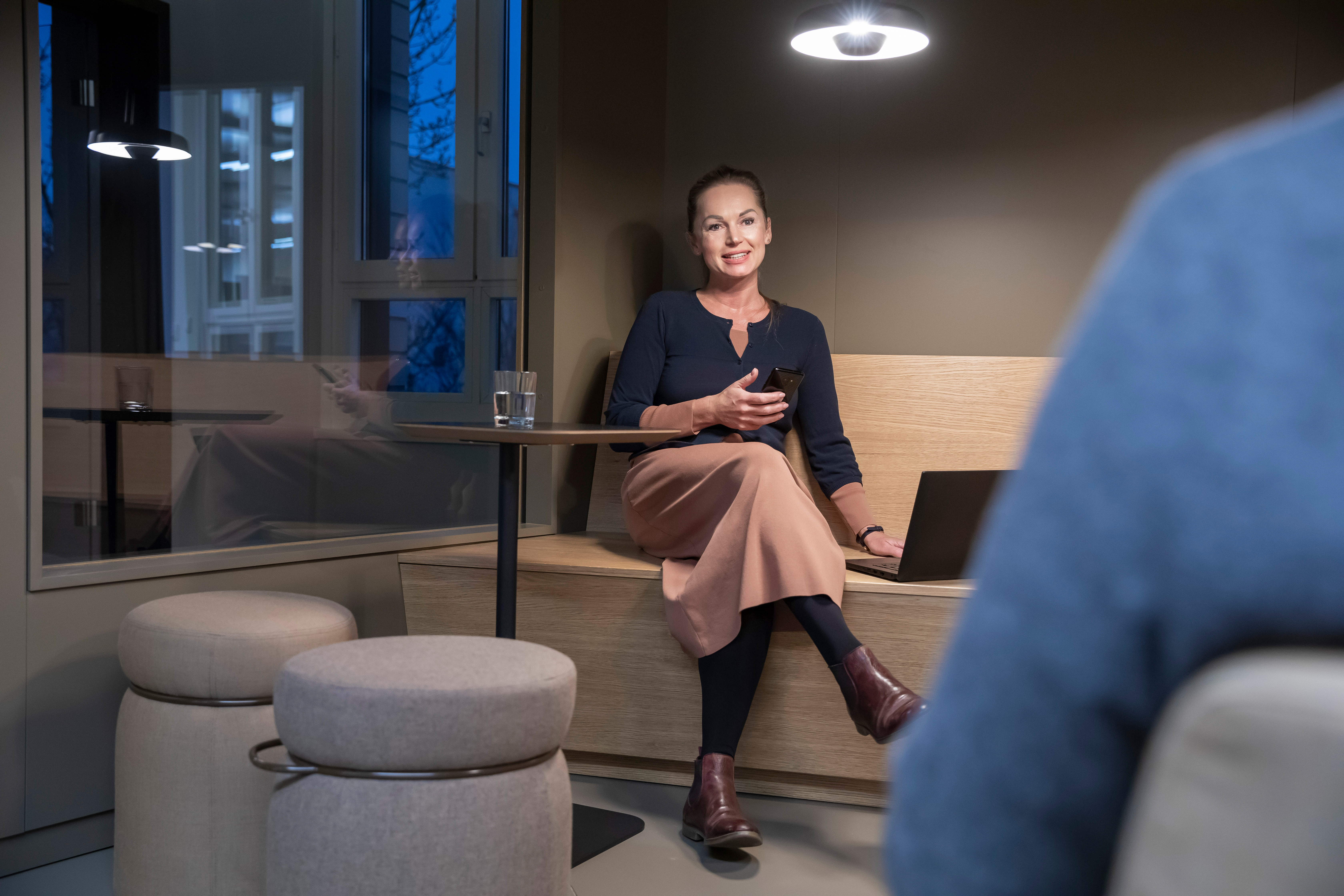 Two employees talking in a lounge area at KWS