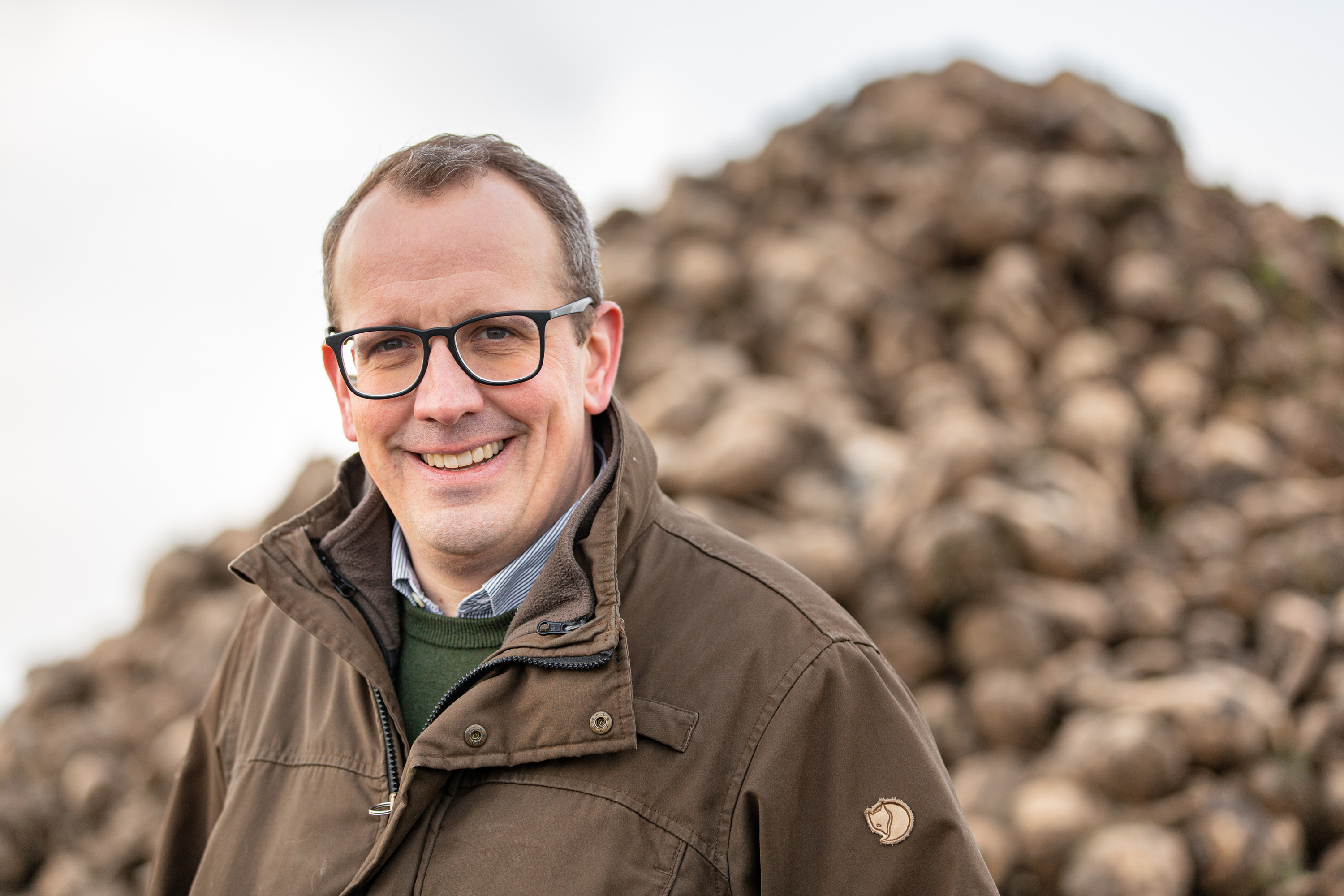 Farmer Christian Flögel is standing in front of a sugar beet clamp. Clamps are a type of storage for bulk goods.