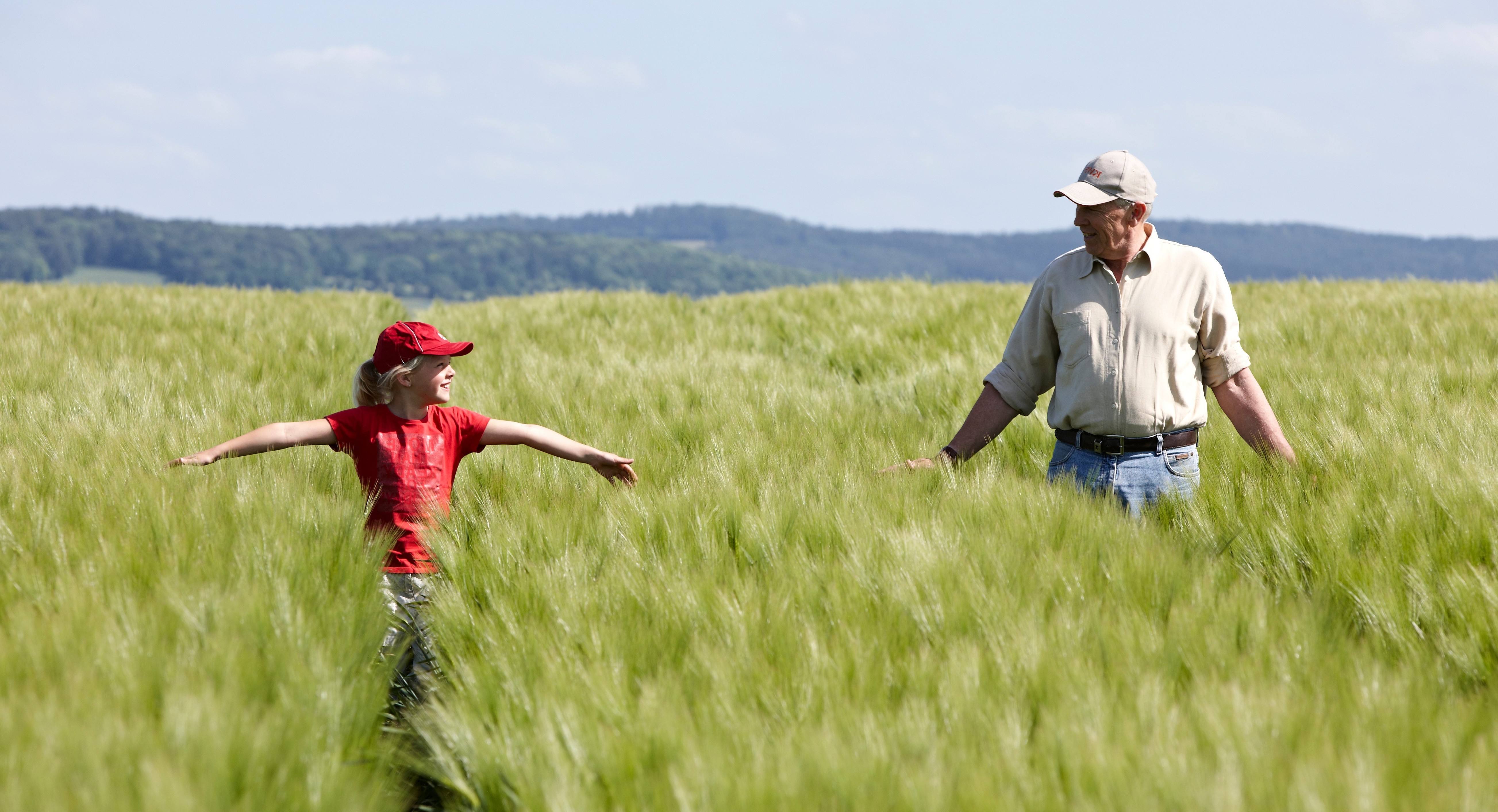 Granddaughter and grandfather in the field