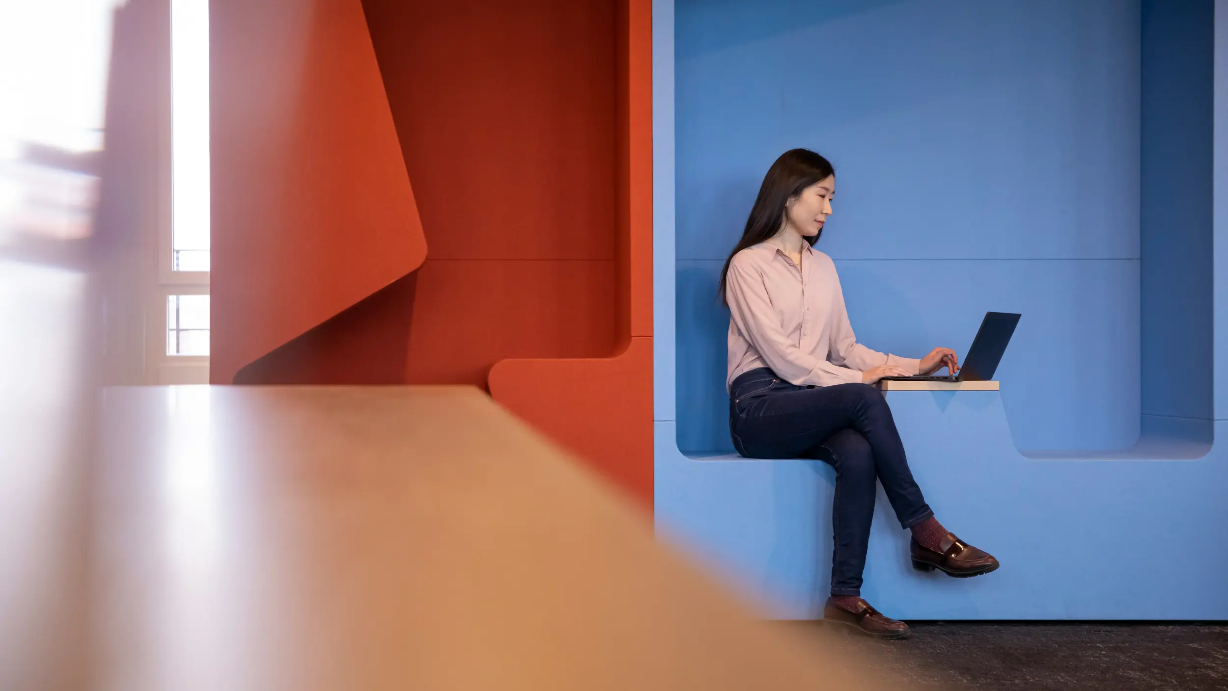 woman sitting on sofa with laptop