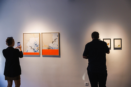 Visitors looking at the art pieces
