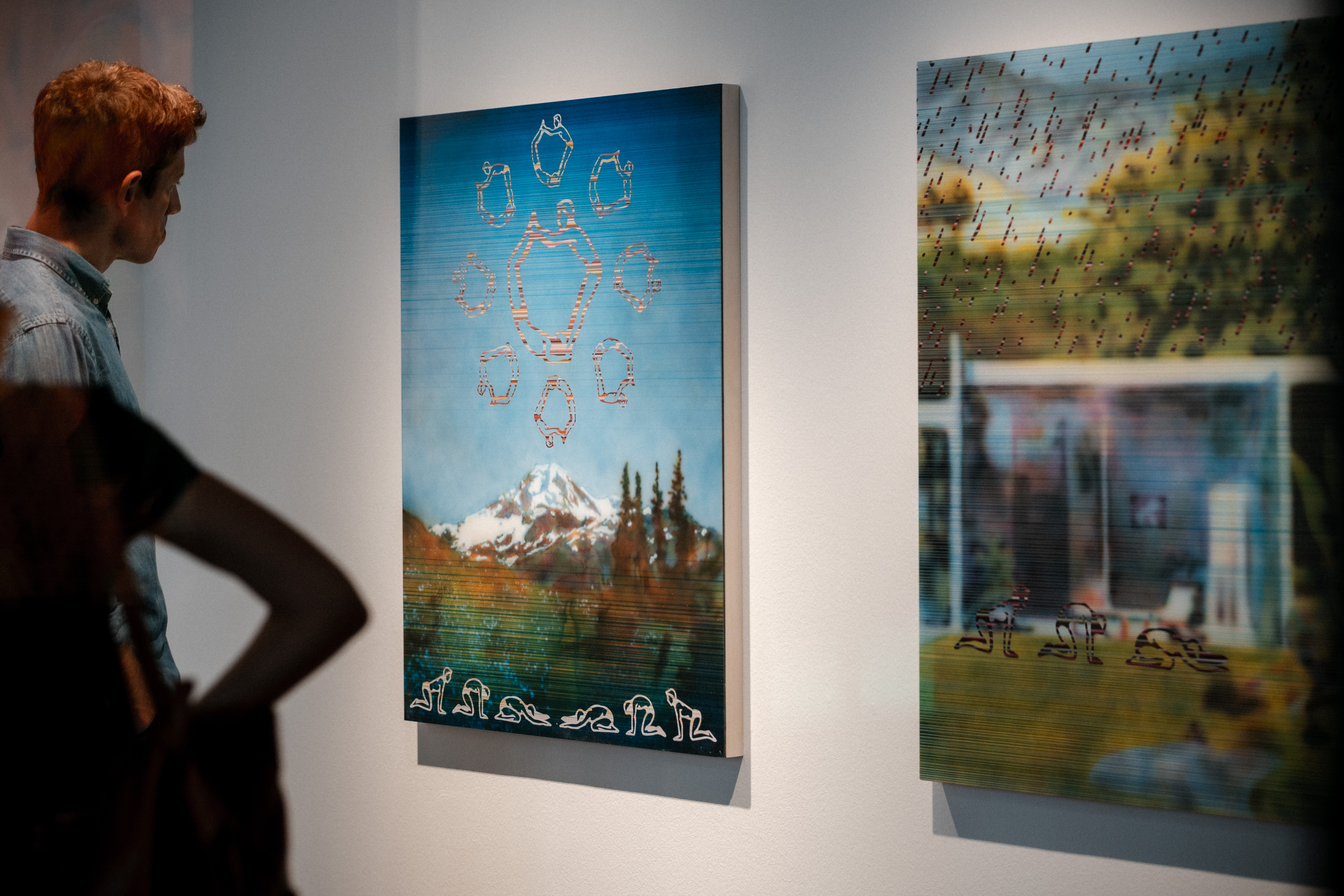 Visitor in front of an artwork during the exhibition opening.