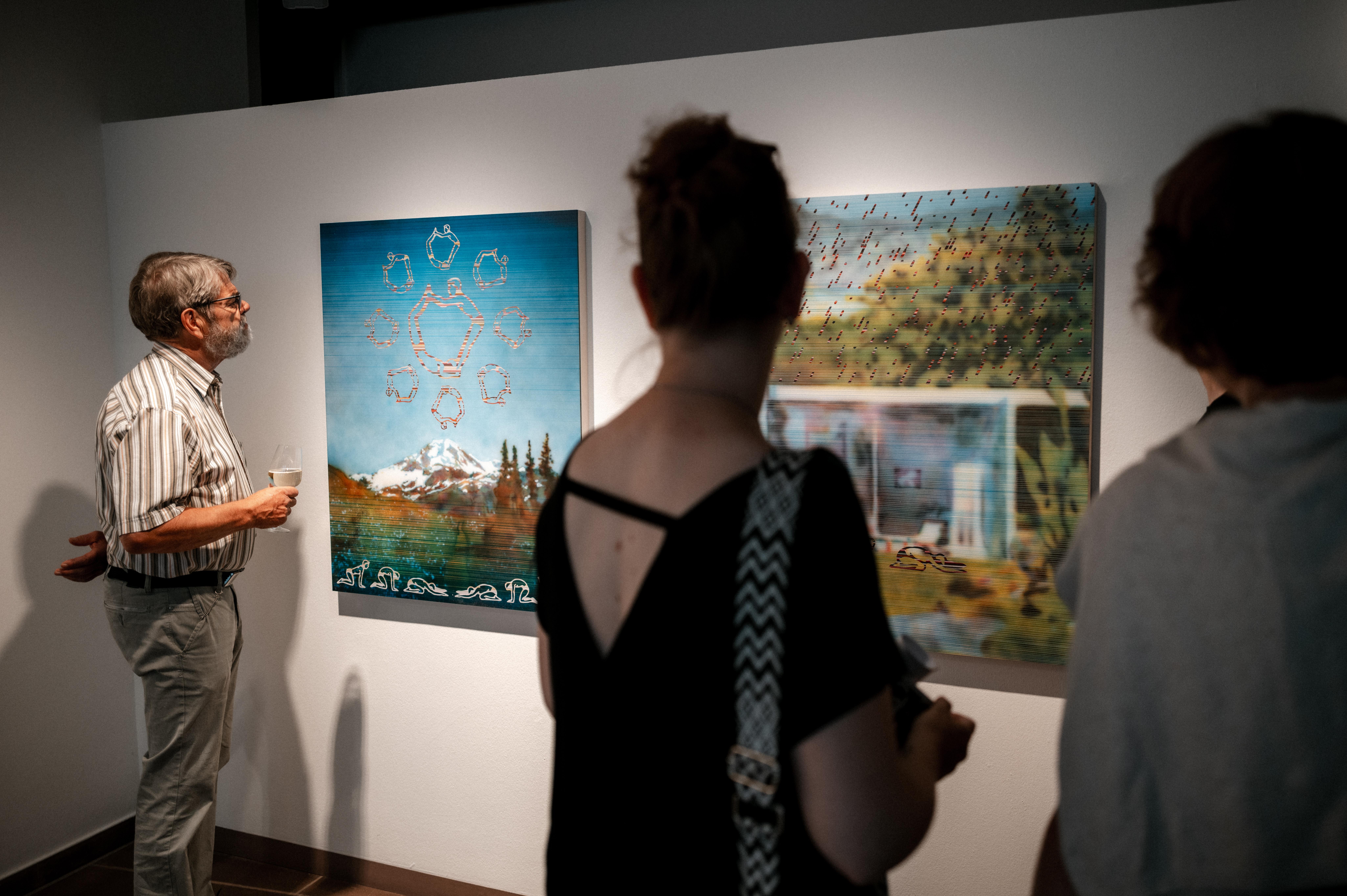 Visitors in front of an artwork during the exhibition opening
